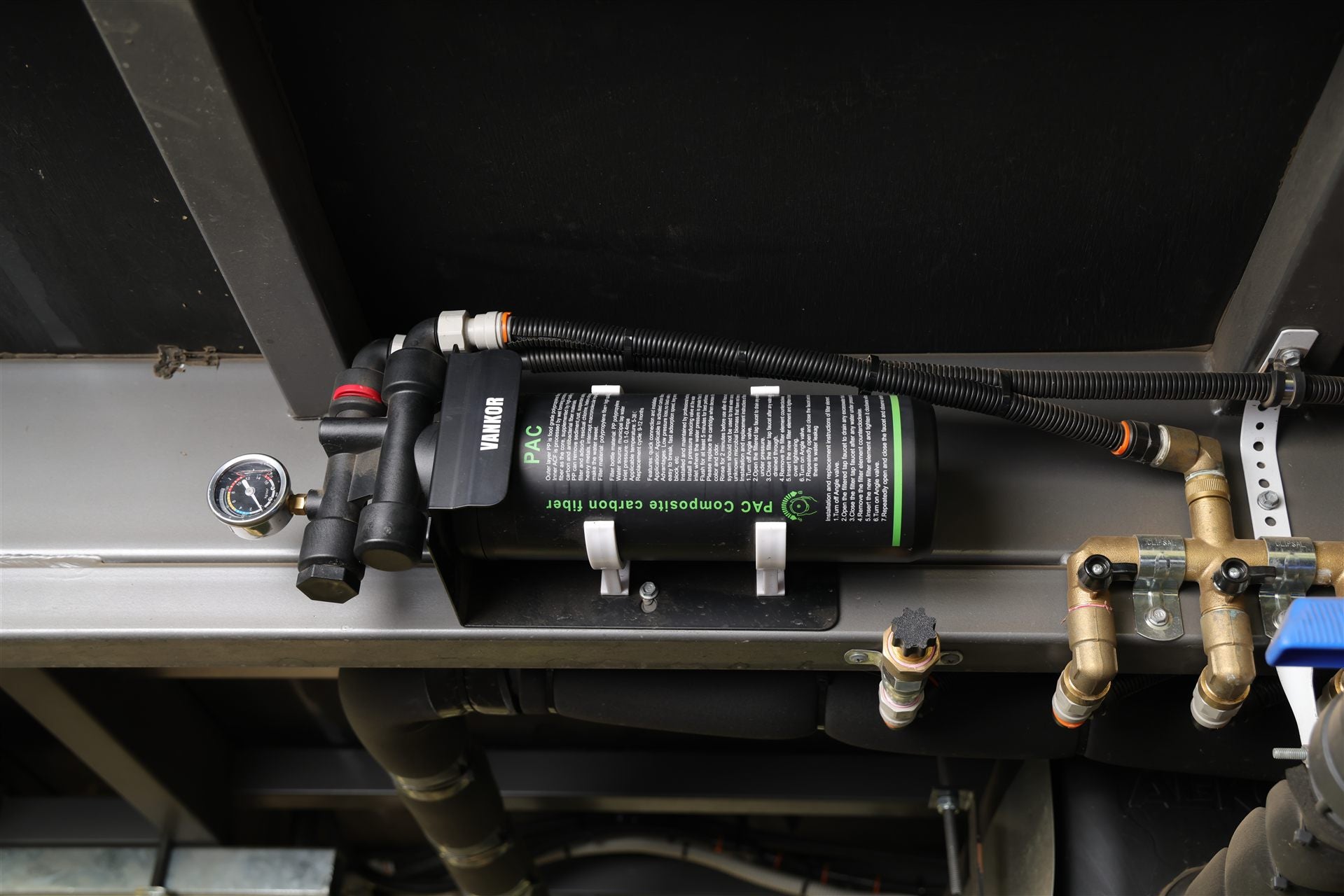 Water filter mounted to under side of caravan