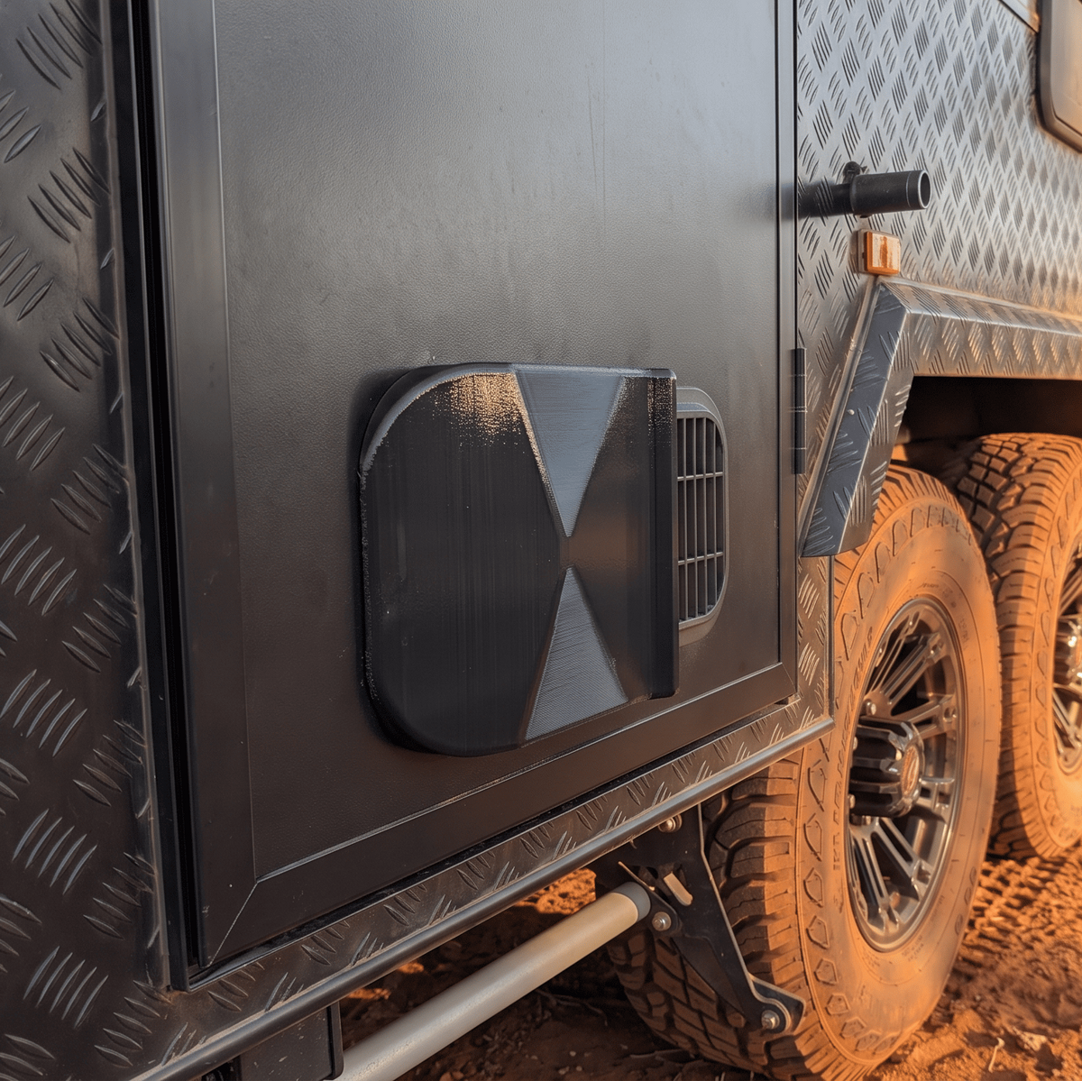 VANKOR caravan door vent dust cover fitted to a black checkerplate off-road caravan